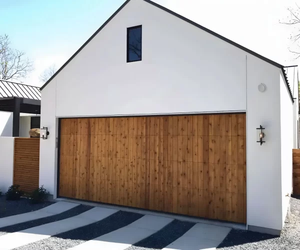 Bent garage door track causing door binding and uneven movement Austin TX
