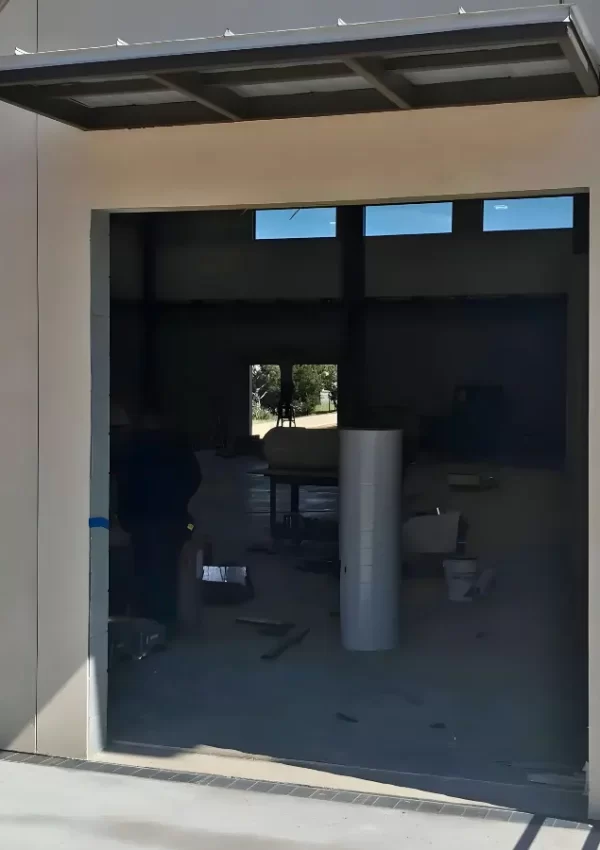 Damaged garage door panel showing dents and cracks requiring replacement Austin TX